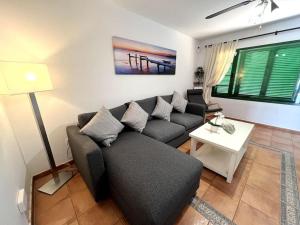 a living room with a couch and a table at The Sallies - 3 bedroom villa with private pool in Tías