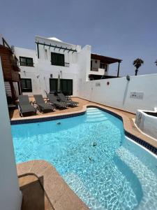 a large swimming pool in front of a building at The Sallies - 3 bedroom villa with private pool in Tías