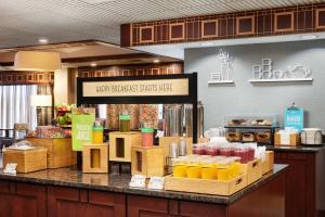 a bakery with a counter filled with different types of juice at Hampton Inn Seymour in Seymour