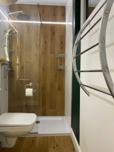 a bathroom with a shower with a toilet and a sink at Domek nad jeziorem in Kruklanki