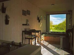 a room with a table and a window and a bed at Casita Colombia - Glamping v Brdech - Příbram 