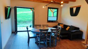 a living room with a table and chairs and a couch at Górska Ostoja in Sieniawa +5 photos