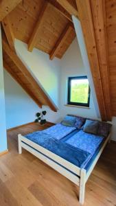 a bedroom with a bed in a room with wooden ceilings at Górska Ostoja in Sieniawa