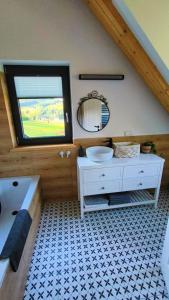a bathroom with a white sink and a mirror at Górska Ostoja in Sieniawa