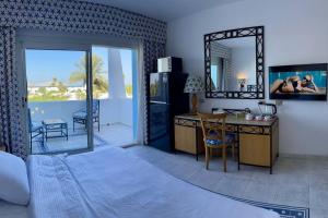 a room with a bedroom with a desk and a mirror at Azure Retreat - Private Luxury Sea View Apartment in Sharm El Sheikh
