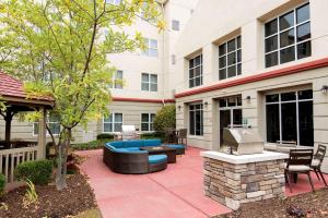 a patio with a blue couch and a grill at Homewood Suites Columbus - Airport in Columbus