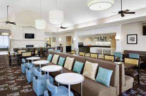 a lobby with a couch and chairs and tables at Homewood Suites Champaign-Urbana in Champaign