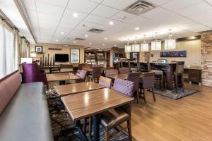 a dining room with wooden tables and chairs at Hampton Inn Columbus I-70E/Hamilton Road in Columbus