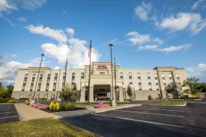 a large white building with a flag in front of it at Hampton Inn & Suites Tilton in Tilton