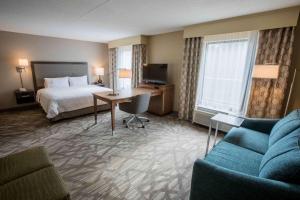 a hotel room with a bed and a desk at Hampton Inn & Suites Tilton in Tilton