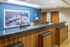an empty waiting room with a large picture of a gun on the wall at Hampton Inn Columbia in Columbia