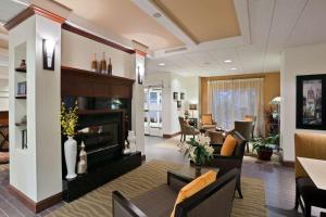 a living room with a couch and a fireplace at Hampton Inn Clifton Park in Clifton Park