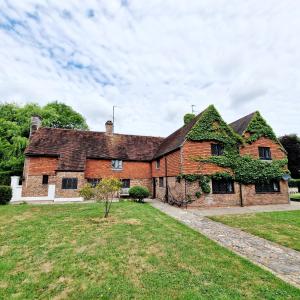 an old brick house with ivy growing on it at Gildridge in Chiddingly