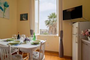 a dining room with a white table and a window at Solo a Sanremo in Sanremo