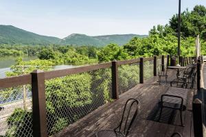 a wooden deck with chairs and a view of a river at Hampton Inn Caryville-I-75/Cove Lake-State Park in Caryville