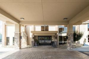 a large building with a porch with chairs in it at Hampton Inn Caryville-I-75/Cove Lake-State Park in Caryville