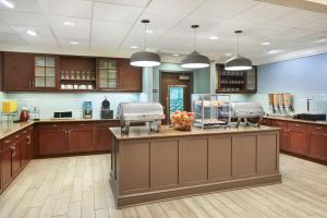 a large kitchen with wooden cabinets and a large island at Homewood Suites by Hilton Columbus in Columbus