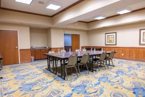 a conference room with a large table and chairs at Hampton Inn Alice in Alice