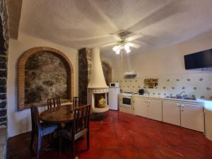 a kitchen with a table and a fireplace in it at Hacienda de las Flores in San Miguel de Allende