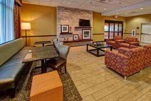 a lobby with a waiting room with chairs and tables at Hampton Inn Crossville in Crossville