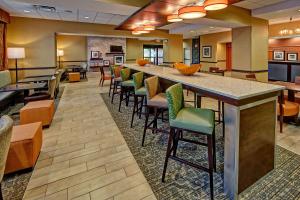 a large lobby with a bar and chairs at Hampton Inn Crossville in Crossville
