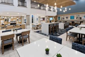 a dining room with tables and chairs and a cafeteria at Hampton Inn & Suites Phenix City- Columbus Area in Phenix City