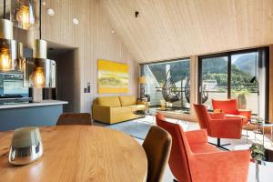 a living room with a wooden table and chairs at Wangen Apartments in Aurland +24 photos