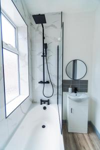 a bathroom with a shower and a sink at Stylish 3 Bedroom House - Central Location in Nottingham
