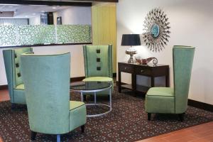 een wachtkamer met stoelen, een tafel en een bureau bij Hampton Inn Cincinnati Northwest Fairfield in Fairfield