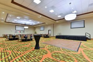 a conference room with chairs and a table in the middle at Hilton Garden Inn West Chester in West Chester