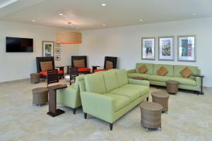 a living room with couches and tables and chairs at Hilton Garden Inn West Chester in West Chester