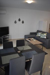 a living room with a couch and a table and chairs at Charming House in Kástron