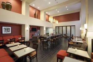 a restaurant with tables and chairs and a bar at Hampton Inn & Suites Conroe I 45 North in Conroe