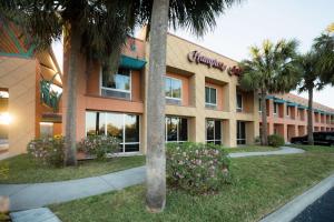 a hotel building with palm trees in front of it at Hampton Inn Brooksville Dade City in Ridge Manor