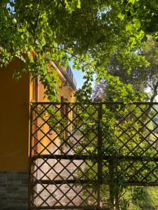 a gate in front of a building with a church at Montenovo Country House in Ostra Vetere