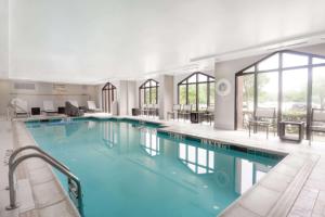 a large pool with blue water in a building at Hampton Inn & Suites Dallas DFW Airport North Grapevine in Grapevine