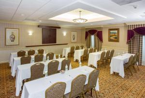a conference room with tables and chairs and a podium at Hampton Inn Coventry-Warwick Area in Coventry