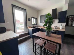 a kitchen with a table and a potted plant at Marina Lodge in Gosport