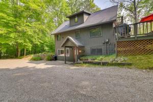 a large house with a driveway in front of it at Gaylord Cabin with Game Room and Lake Access! in Gaylord