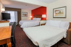 a hotel room with two beds and a flat screen tv at Hampton Inn Dayton Fairborn Wright Patterson AFB in Fairborn