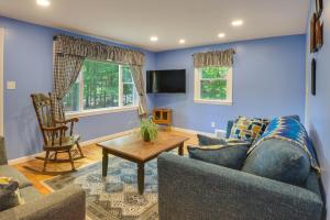 a living room with a couch and a table at Dog-Friendly Fitchburg Vacation Rental, Hike and Ski in Fitchburg