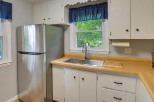 a kitchen with white cabinets and a stainless steel refrigerator at Dog-Friendly Fitchburg Vacation Rental, Hike and Ski in Fitchburg +16 photos