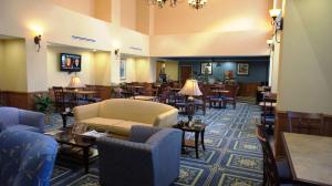 a hotel lobby with tables and chairs and a couch at Hampton Inn Dallas-Rockwall in Rockwall