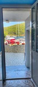 an open door with a view of a marina at Guesthouse Porto in Cres