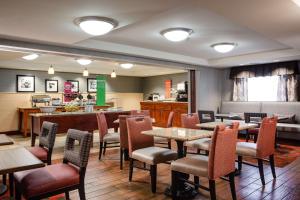 a restaurant with tables and chairs and a counter at Hampton Inn Dubuque in Dubuque