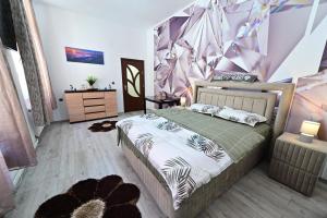 a bedroom with a bed and a purple wall at A&N Central Apartment in Sibiu