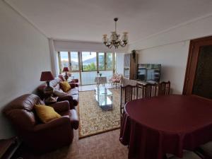 a living room with a table and a couch at Mar y Montaña in Laredo