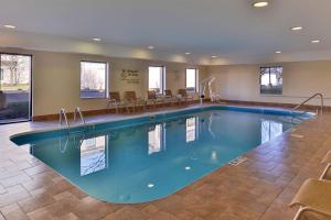 a pool in a hotel room with chairs around it at Hampton Inn & Suites Dayton-Vandalia in Murlin Heights