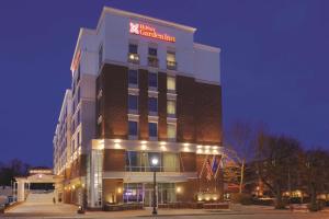 a hotel building with a sign on top of it at Hilton Garden Inn Falls Church in Falls Church