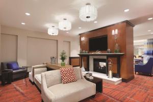 a living room with a couch and a fireplace at Hilton Garden Inn Falls Church in Falls Church